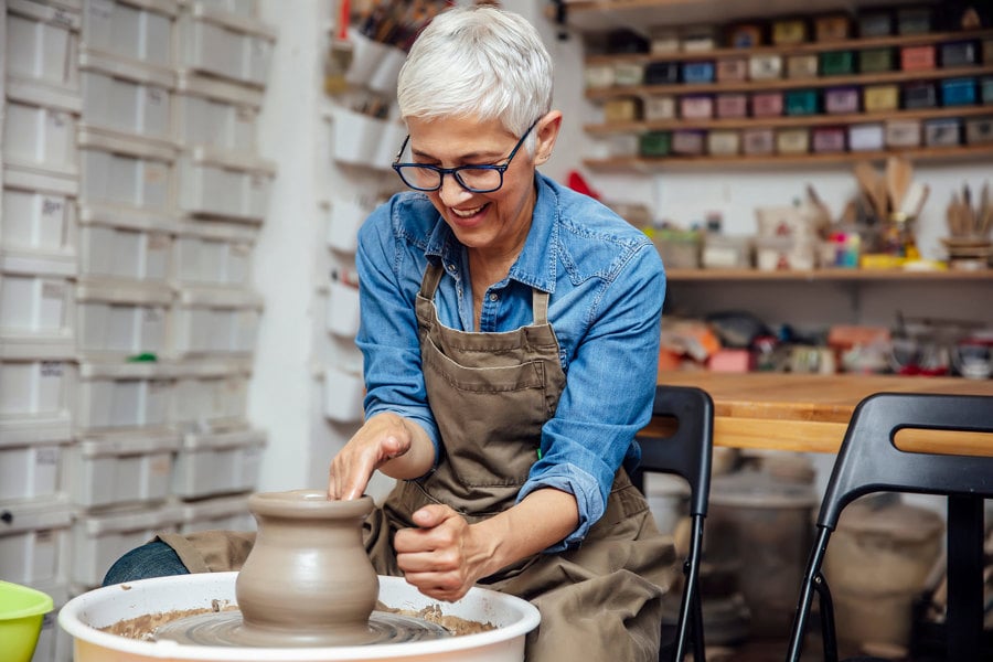 Elderly female working on potter