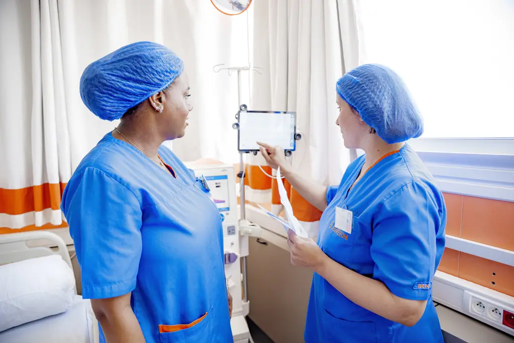 Diaverum nurses reviewing dialysis treatment information in a renal care clinic.