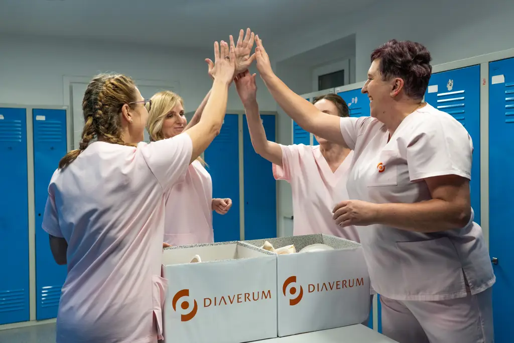 Diaverum nurses celebrating teamwork in a clinic staff area.